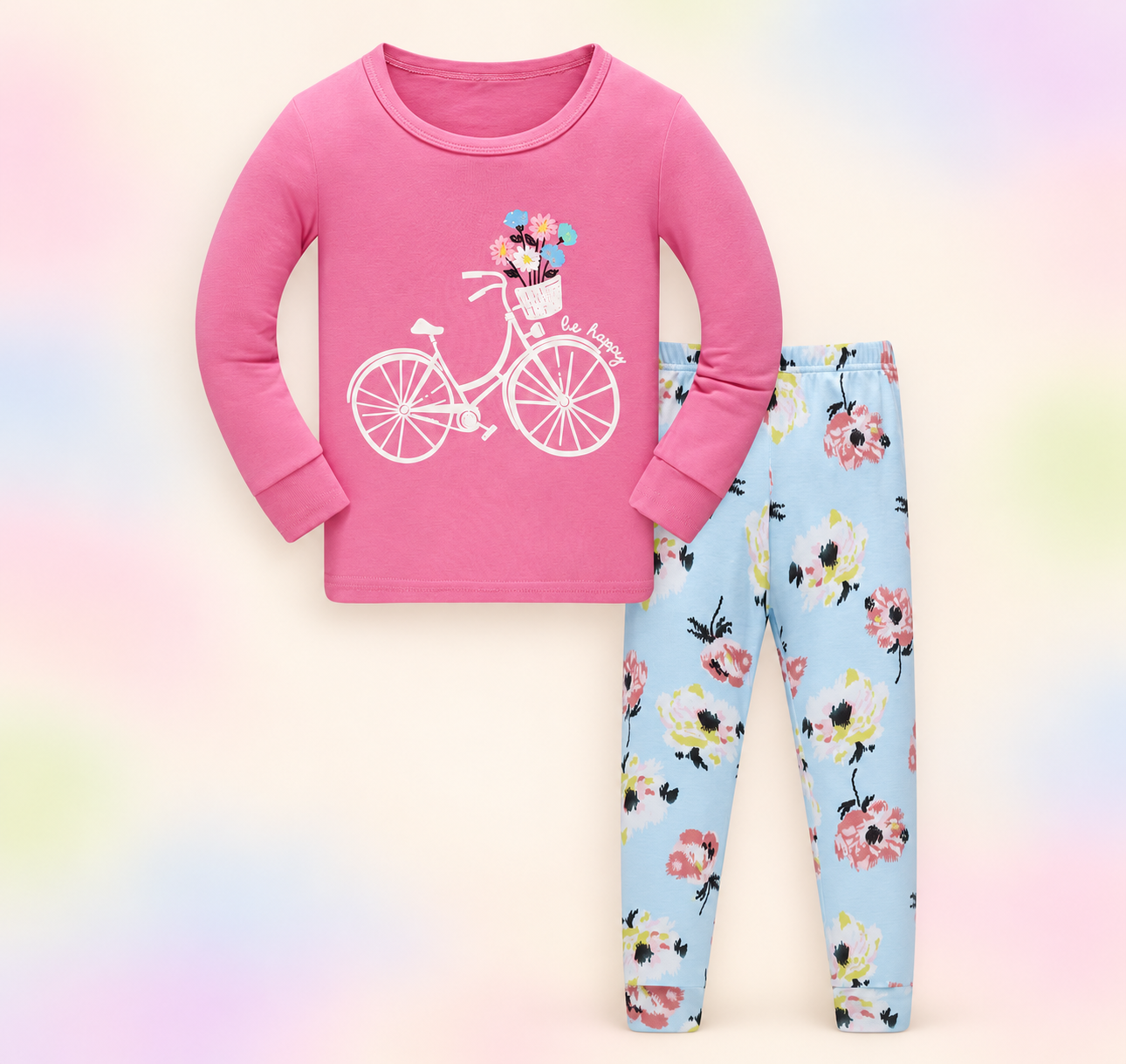 Pink bicycle print pajama set with blue floral pants on a soft pastel branded studio background.